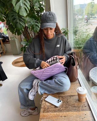 Amaka Hamelijnck wearing jeans and a sweatshirt