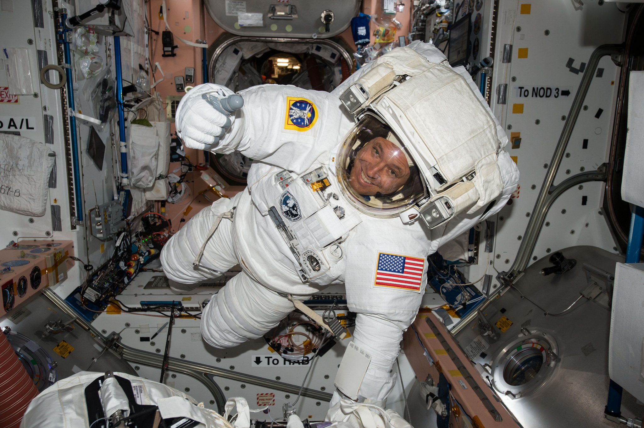NASA astronaut Jack Fischer gives a thumbs up sign while wearing an Extravehicular Mobility Unit (EMU) spacesuit before a spacewalk May 12, 2017 on the International Space Station.  Fischer and NASA astronaut Peggy Whitson will perform a repair spacewalk on Tuesday, May 23.