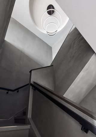 grey concrete stairs and landing in the Poliform Penthouse design in Gansevoort Meatpacking hotel in Manhattan New York