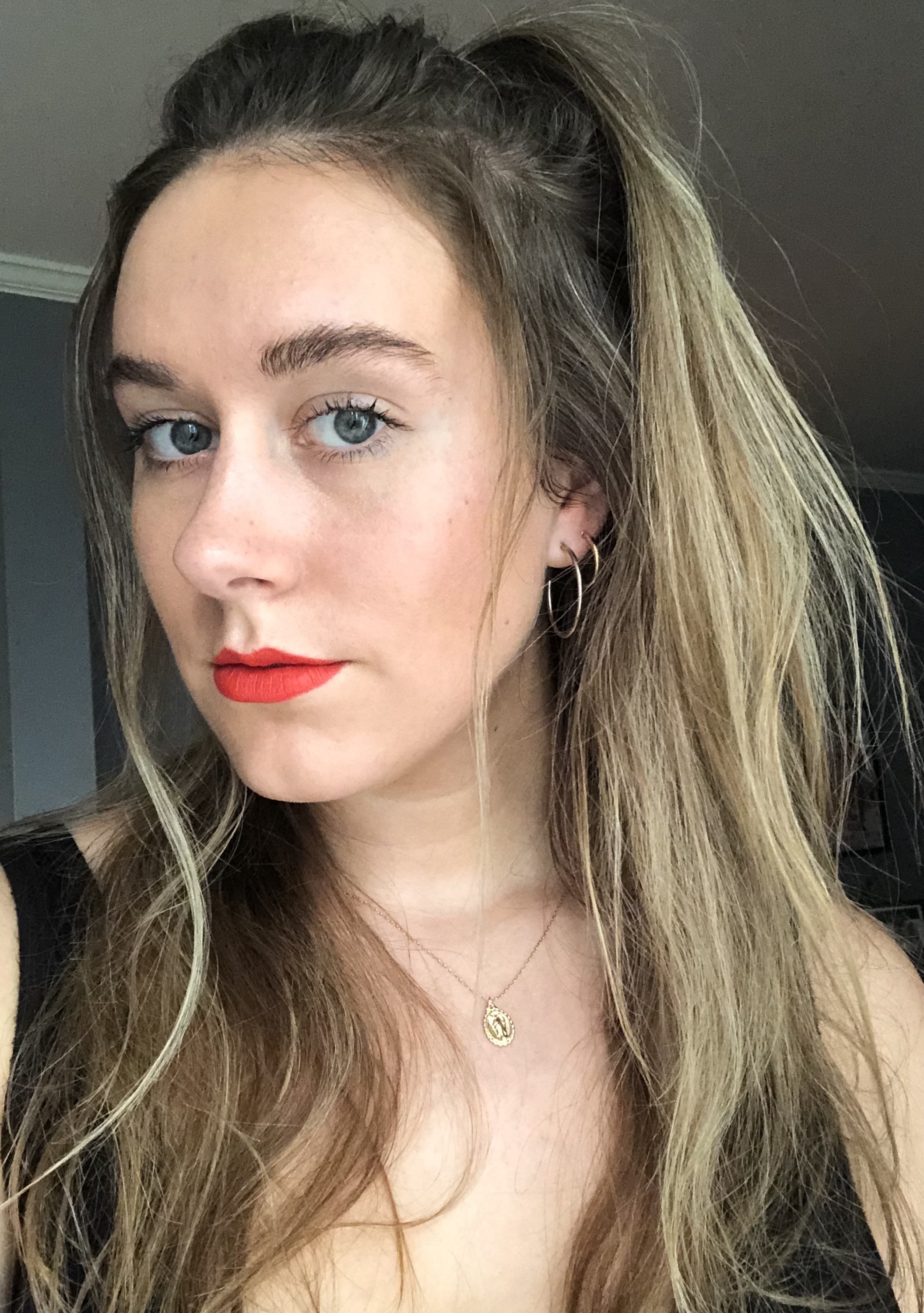 Kaitlyn McLintock testing red lipstick.