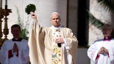 Pope Leo XIV sprinkles holy water during Easter Sunday Mass at the Vatican