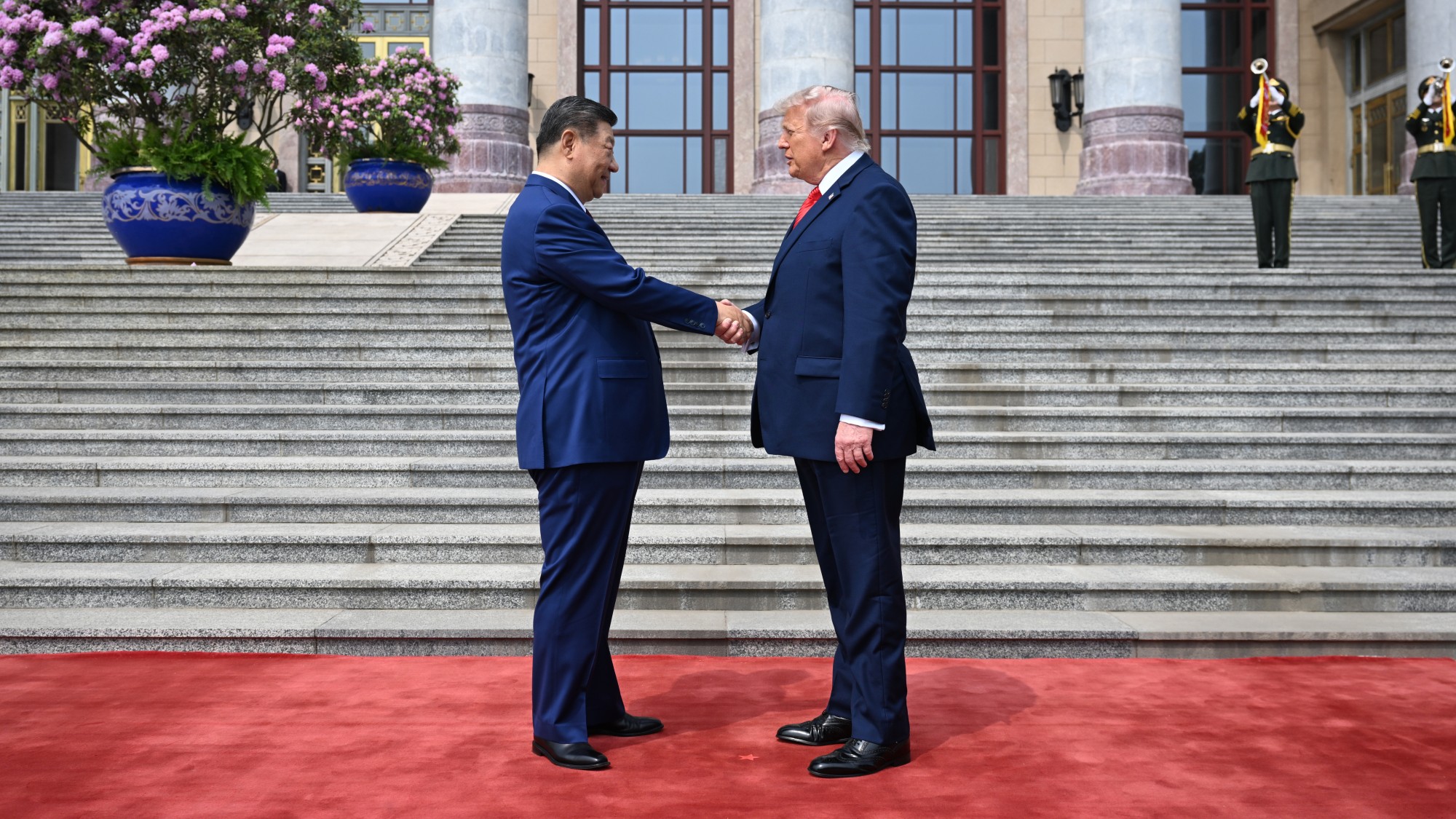 Xi Jinping and Donald Trump shaking hands outside the Great Hall of the People in Beijing