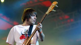 Gary "Mani" Mounfield of Primal Scream performs onstage on the third day of the Roskilde Festival on 1st July in Roskilde, Denmark.