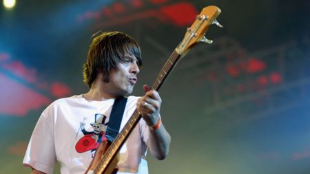 Gary "Mani" Mounfield of Primal Scream performs onstage on the third day of the Roskilde Festival on 1st July in Roskilde, Denmark.
