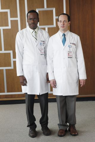 two men in doctors white coats standing next to each other in a still from better off ted