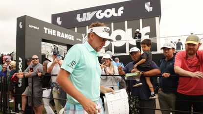 Ian Poulter walks past fans