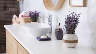 A bathroom sink with dried lavender on either side