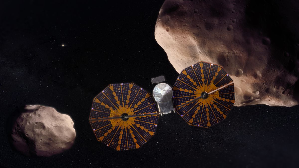 A spacecraft with two round solar panel wings on either side of it. In the background, there are two asteroids. The one on the right is bigger than the one on the left.