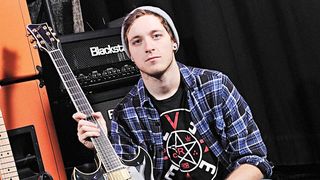Architects guitarist Tom Searle holding a guitar