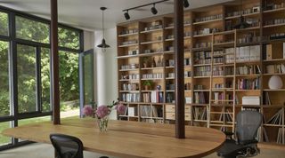 A well-organized floor-to-ceiling bookshelf with ladder