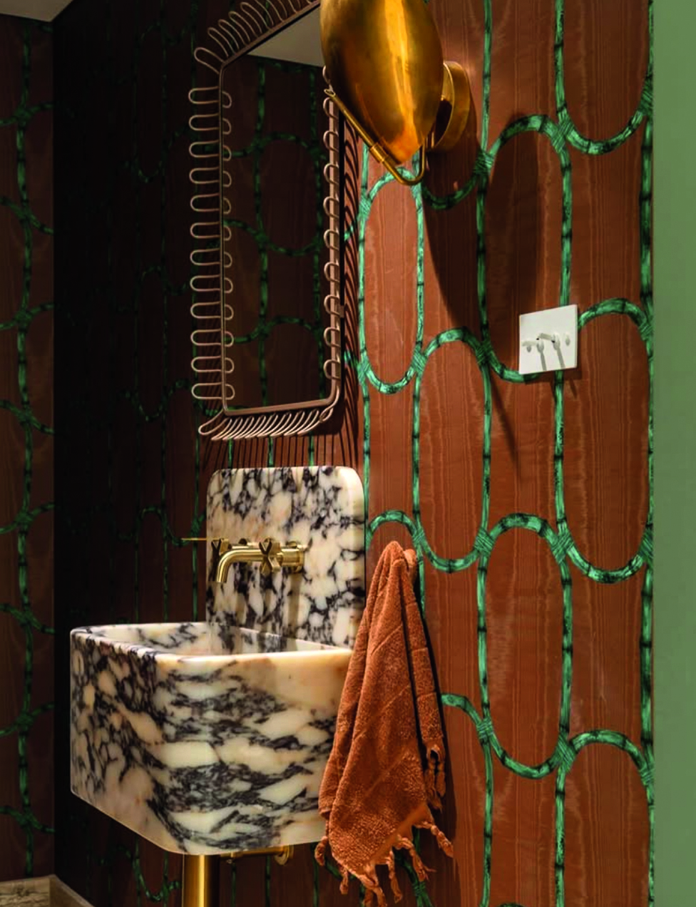 a marble sink in a wood and green bathroom