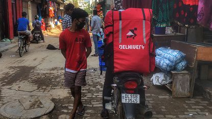 Delhivery rider on a scooter