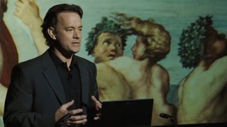 Tom Hanks delivers a speech onstage about religious symbols in The Da Vinci Code