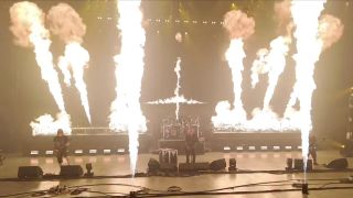 Slayer performing on a stage with lots and lots of fire