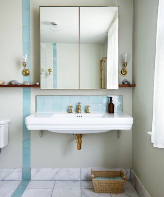 neutral bathroom with white basin and pale blue zelige tile backsplash