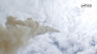 Shuttle Atlantis trails smoke.