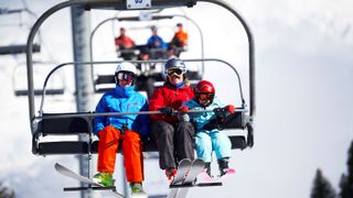 Mother and two sons on ski lift