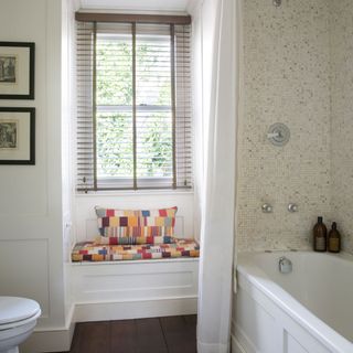bathroom with white wall bathtub and window