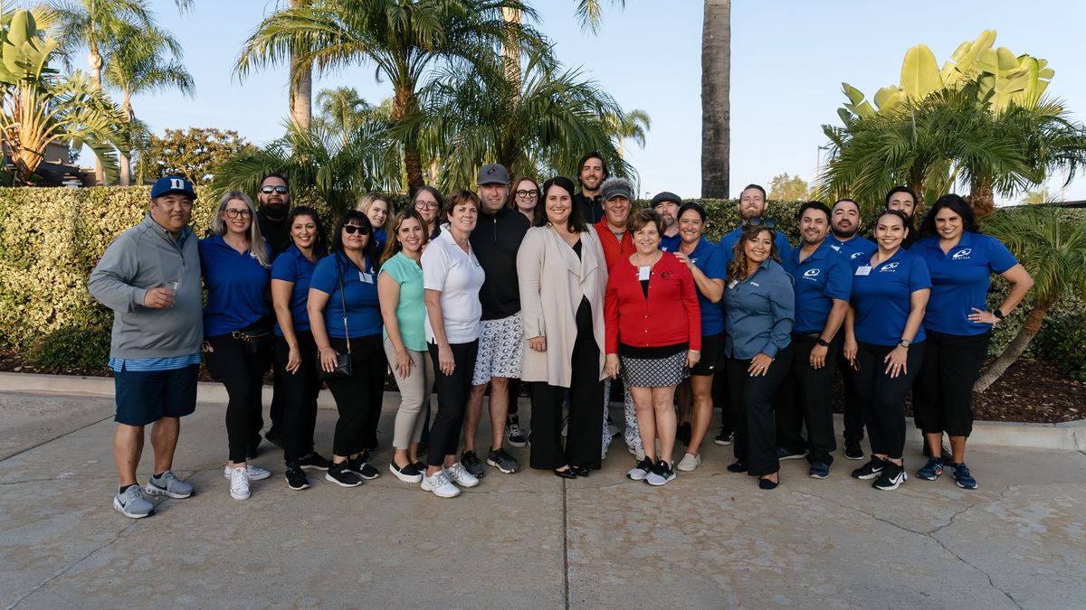 A large group of employees smiling after hosting Spinitar&#039;s Golf for Hope.