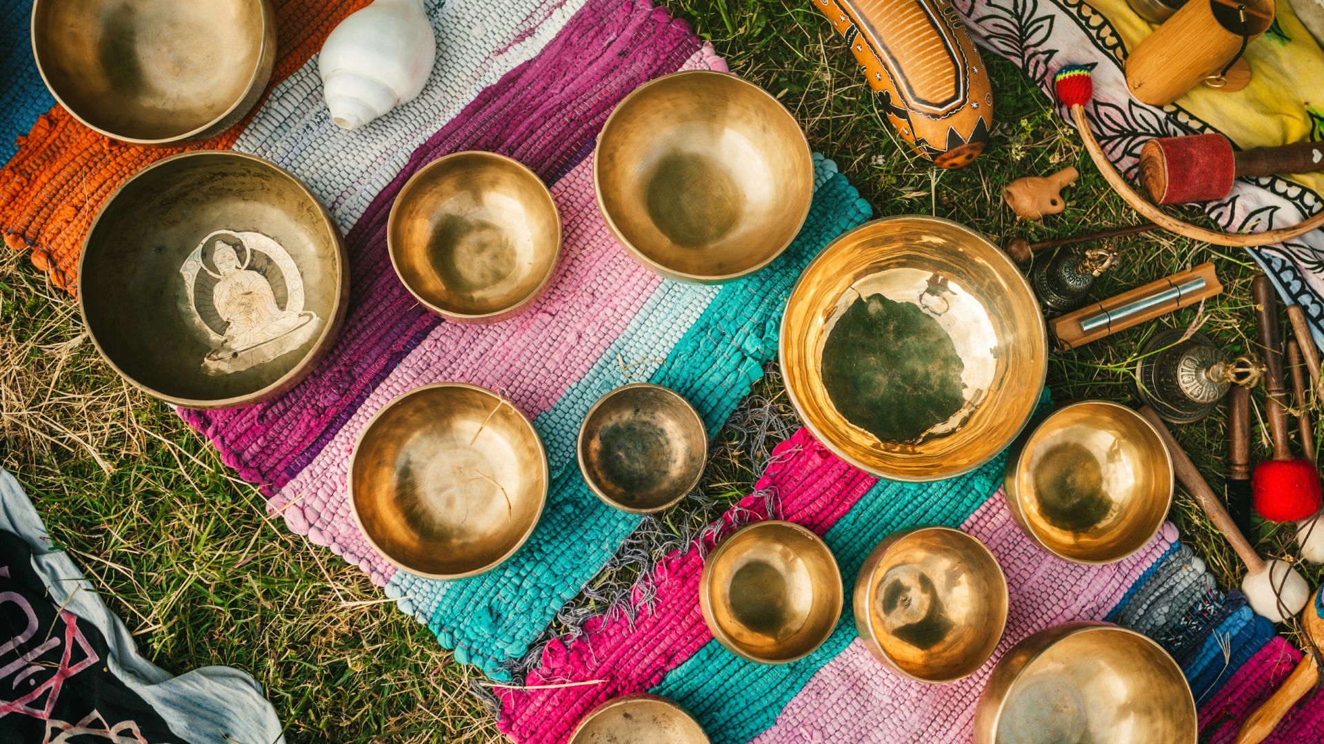 singing bowls on a colourful blanket