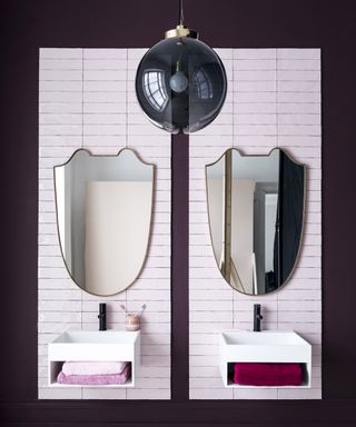 Burgundy bathroom micro trend, twin sinks in a dark red painted room