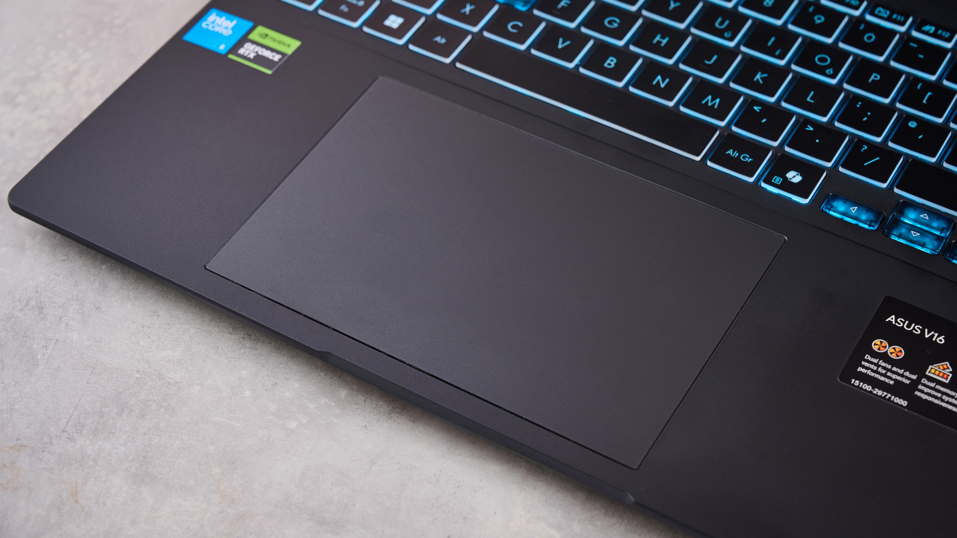 Close-up of touchpad on Asus V16, on a desk