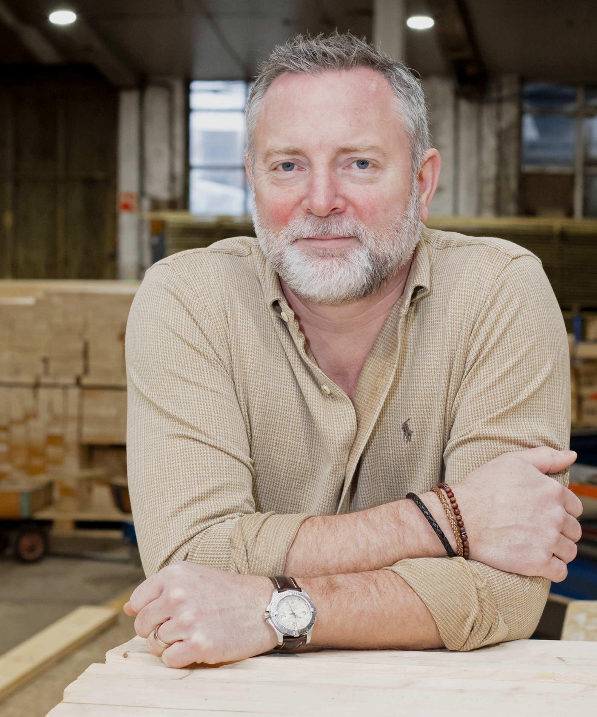 man with beard and grey hair wearing check shirt