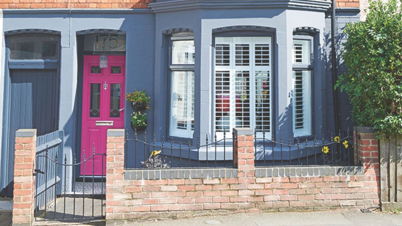 Bright pink front door on renovated Victorian house