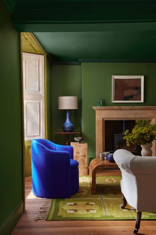 a green living room with a slightly contrasting green painted ceiling