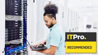 man working on laptop in data centre