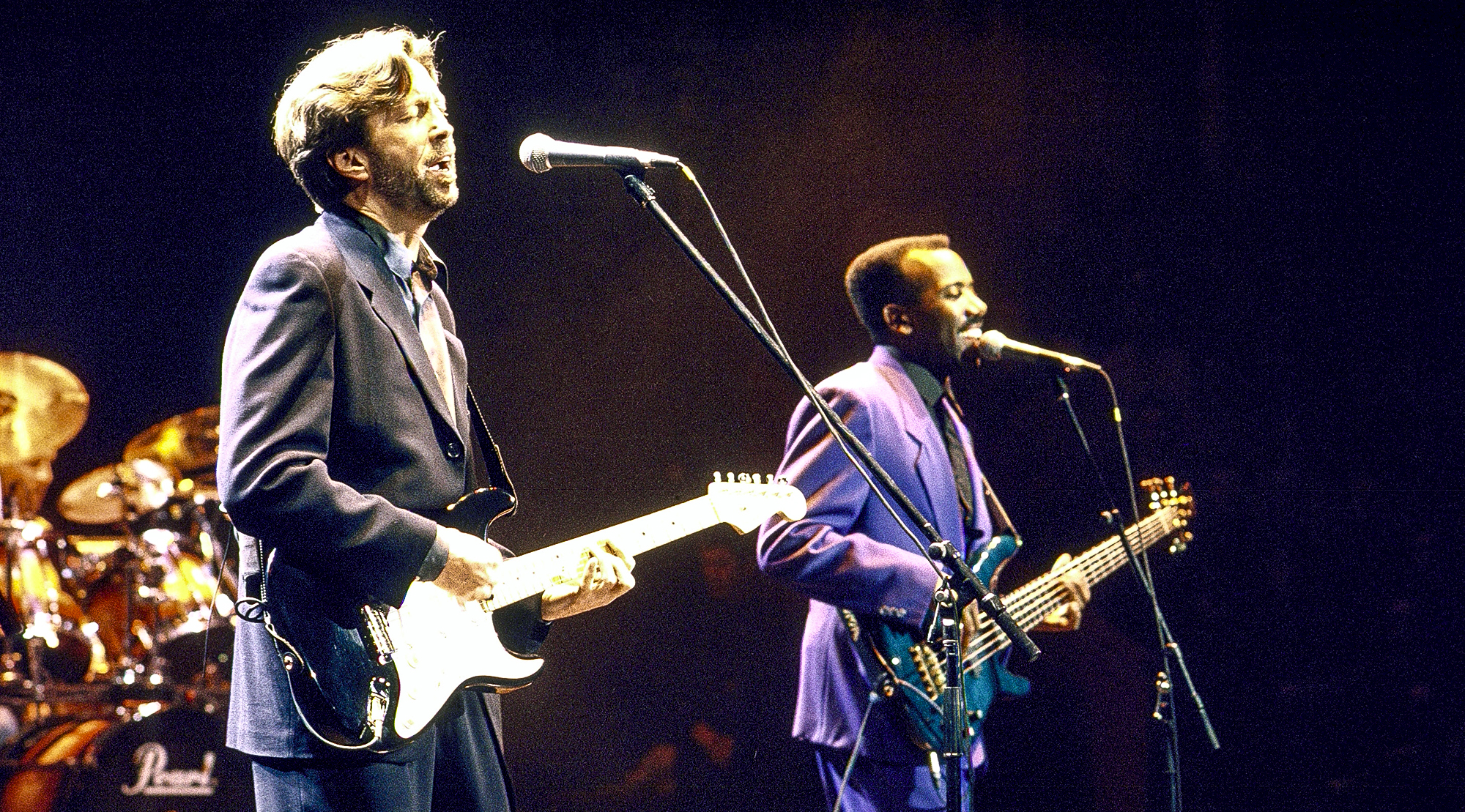 (L-R) Blues guitarist Eric Clapton &amp;amp; jazz bassist Nathan East performing onstage.