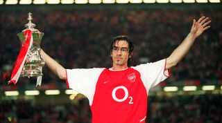 Robert Pires celebrates with the FA Cup trophy after the 2003 FA Cup final between Arsenal and Southampton at the Millennium Stadium on May 17, 2003 in Cardiff, United Kingdom.