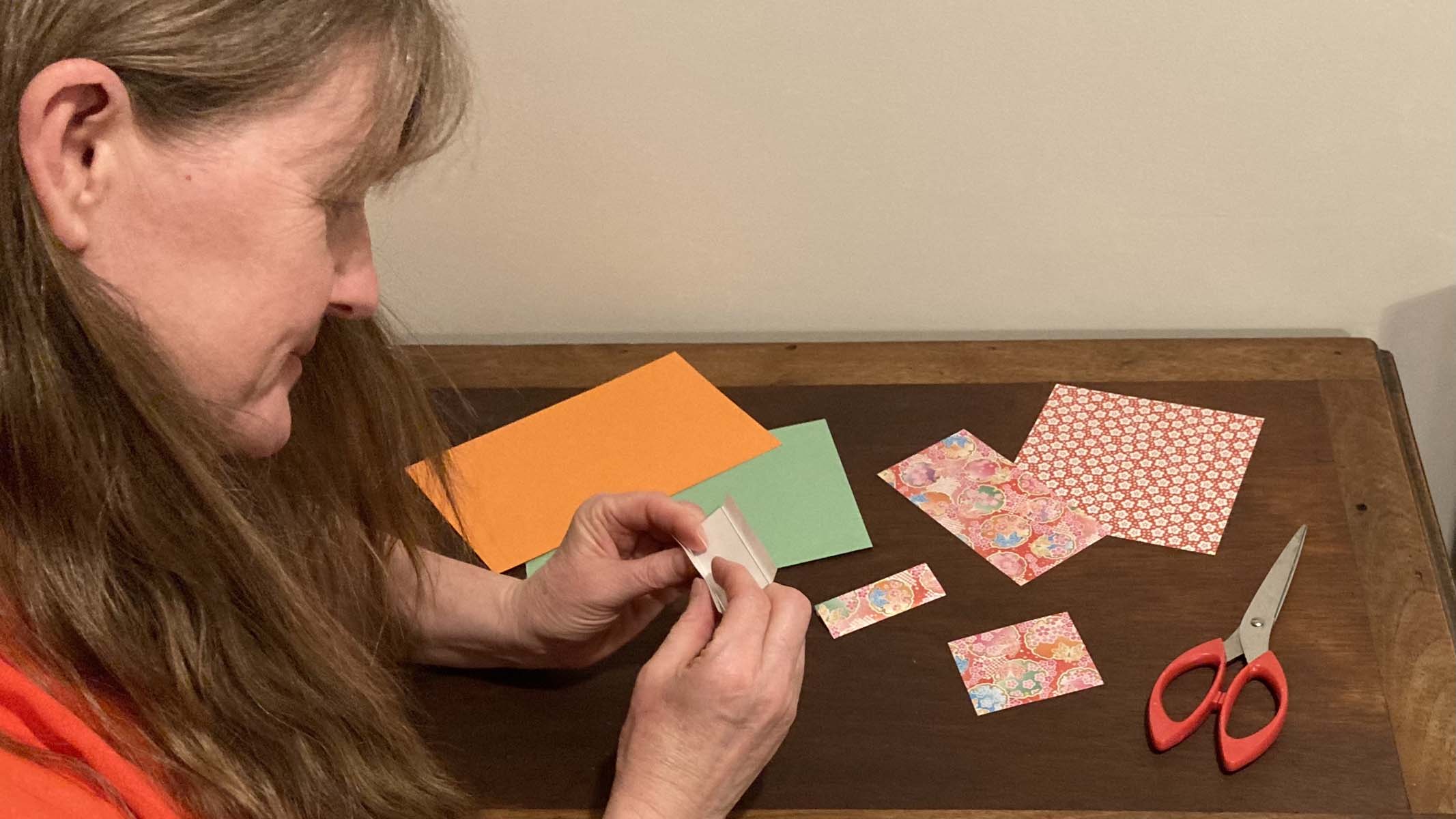 woman making paper microscope slide wraps