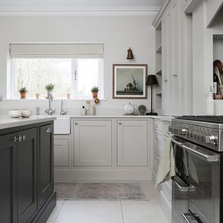 a neutral shaker-style kitchen with a large black range cooker