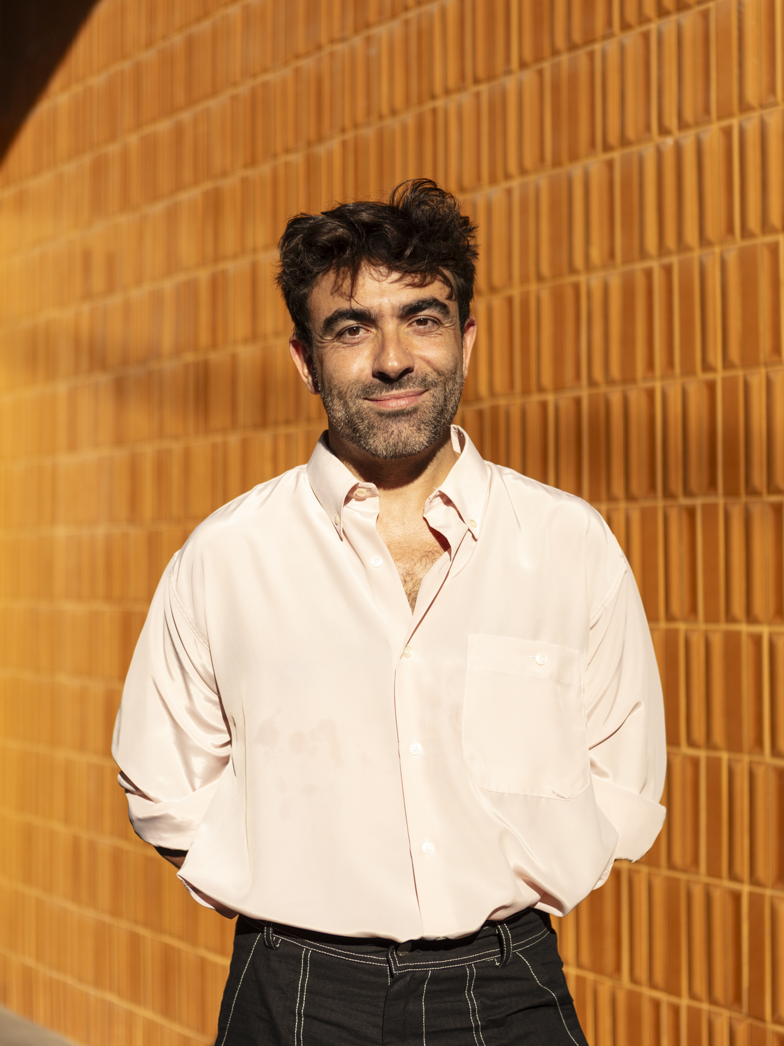 Javier Pe&amp;ntilde;a Iba&amp;ntilde;ez portrait against terracotta wall