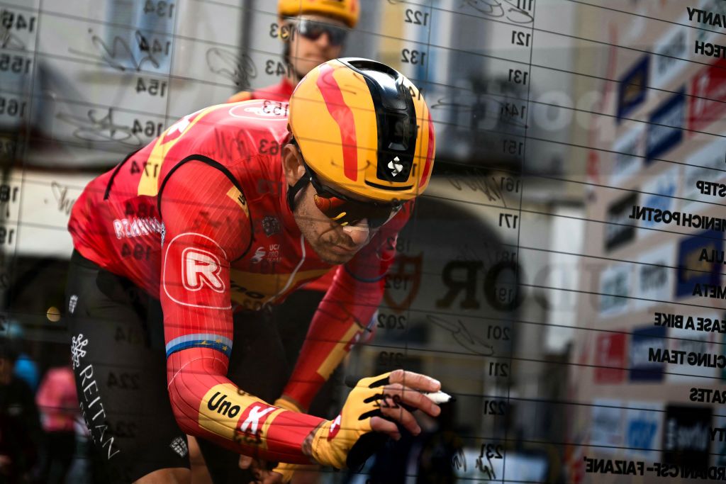 Uno-X Mobility Norwegian rider Alexander Kristoff signs the board prior to the start of the 115th Milan-SanRemo one-day classic cycling race, in Pavia, on March 16, 2024. (Photo by Marco BERTORELLO / AFP)