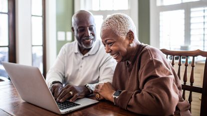 Couple looking at their laptop