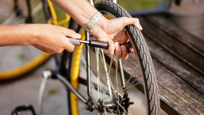 Pumping up a bike tyre