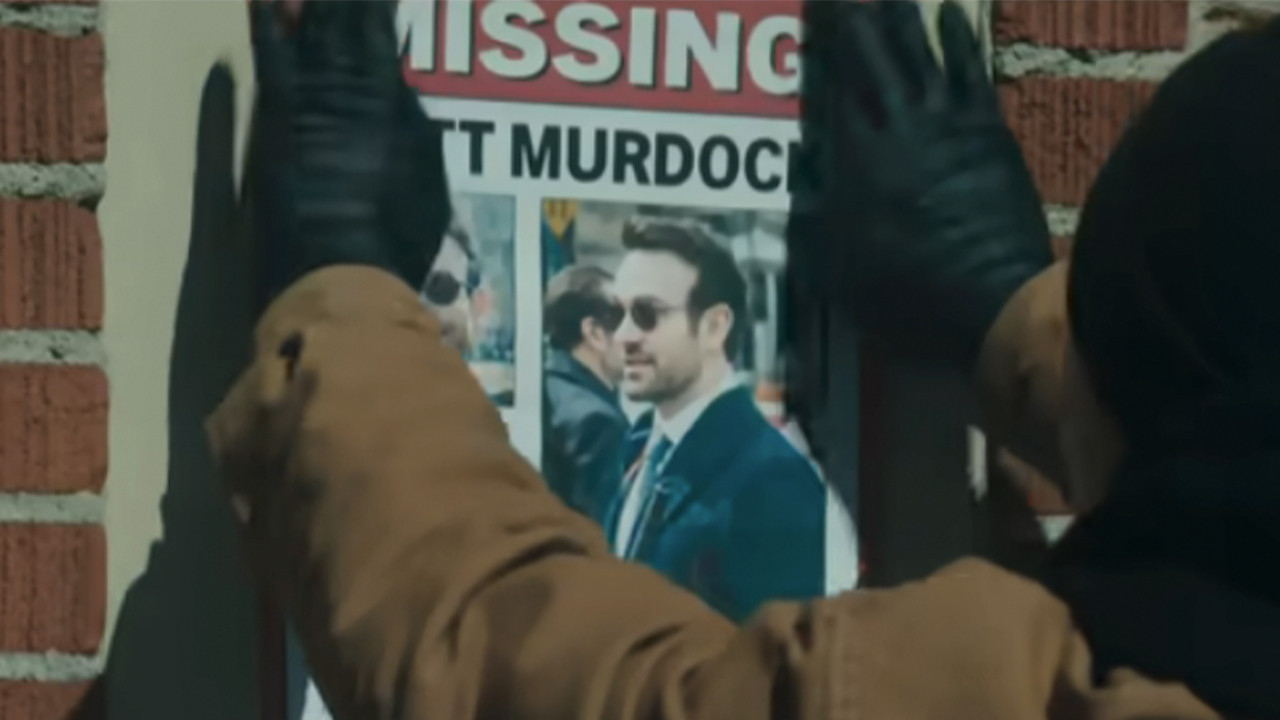 A masked man putting up a missing poster with Matt Murdoch on it in Daredevil: Born Again Season 2