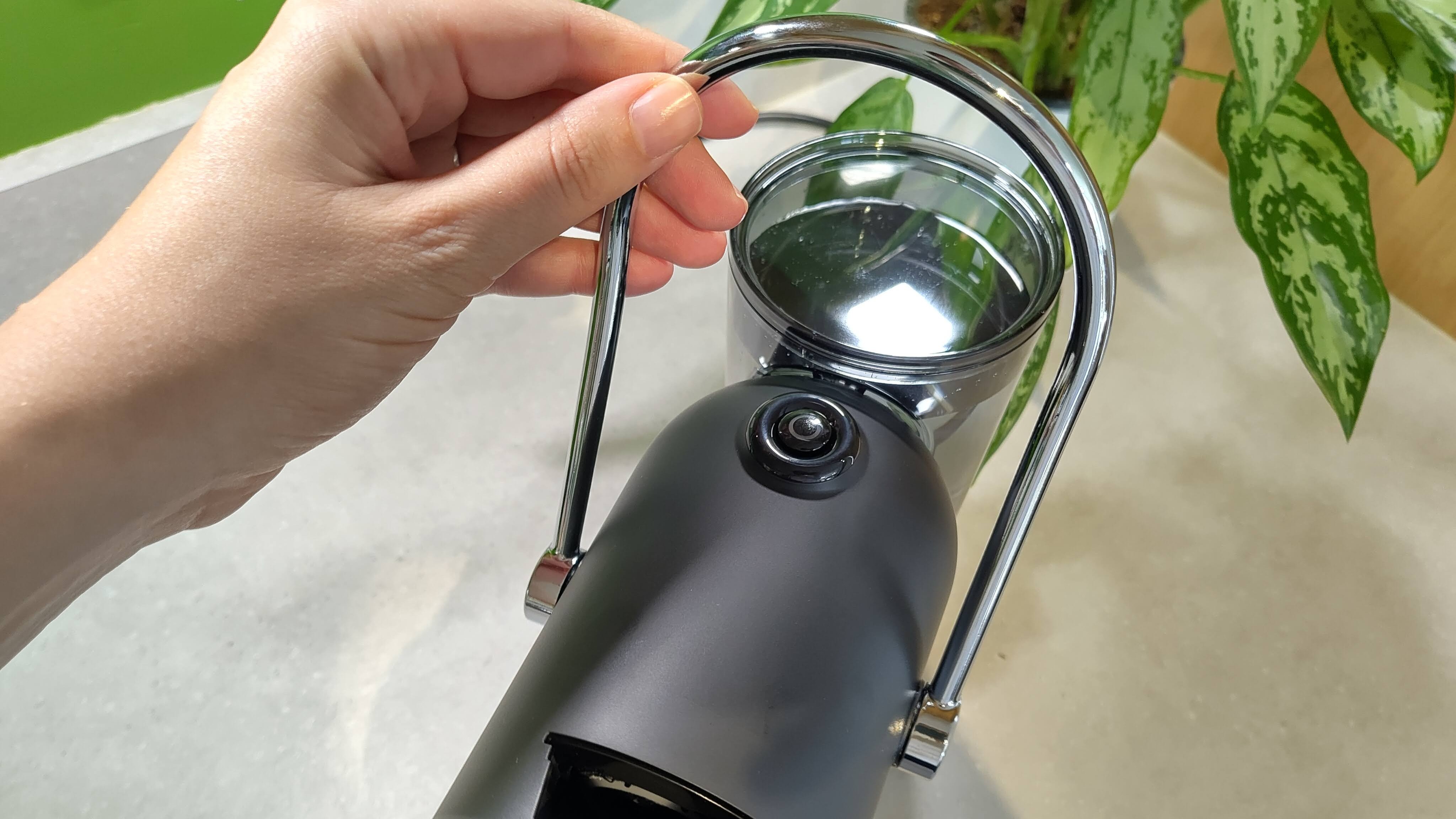 Person raising handle of Lavazza Jolie Evo coffee maker
