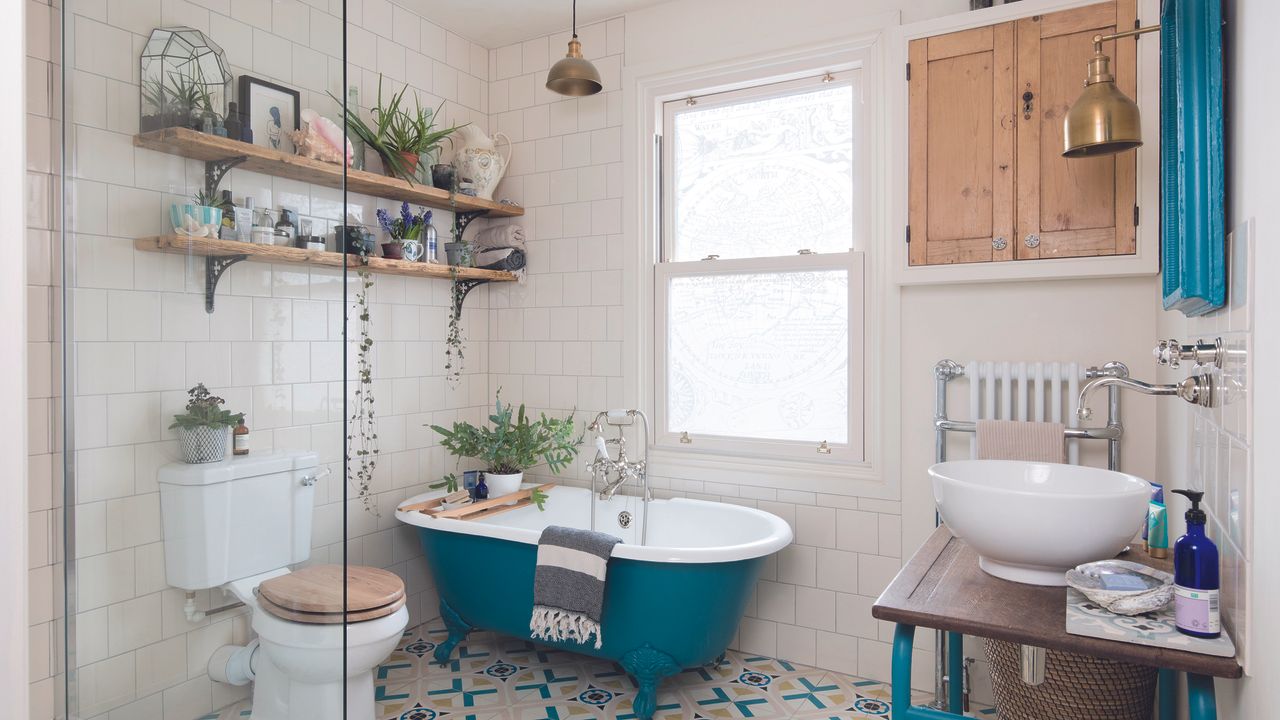 Bathroom with blue bath and brass pendant