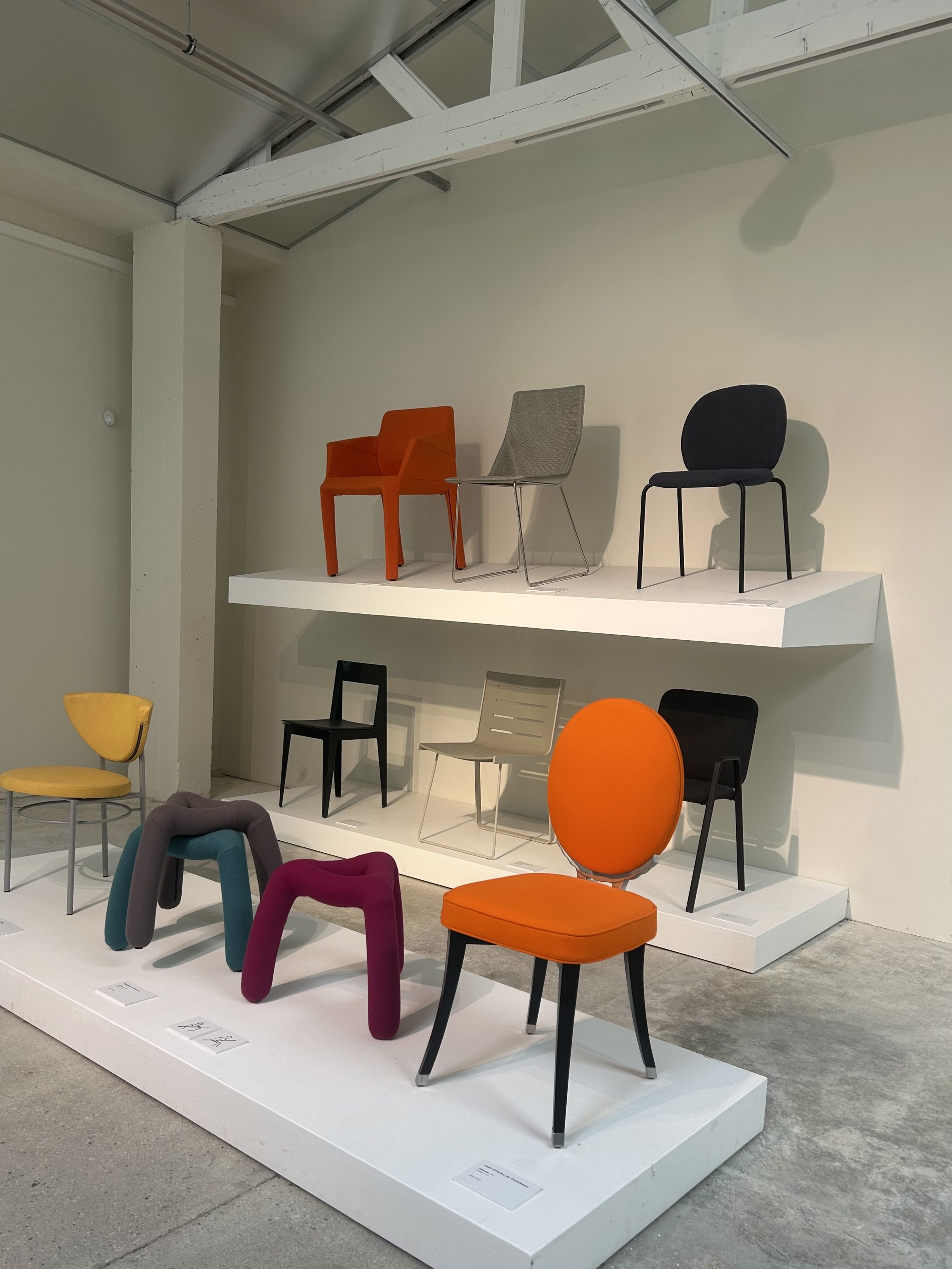 A display of colourful Ligne Roset chairs and sculptural stools at Studio 1860, tracing decades of experimental furniture design.