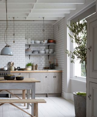 An airy kitchen with open shelving and an island