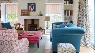 neutral living room with blue sofa and pink sofa