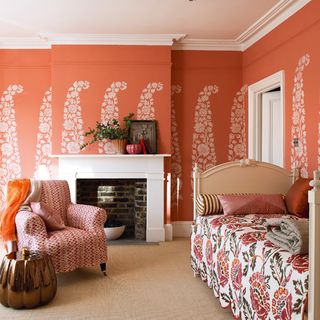 living room with stencil design on orange wall