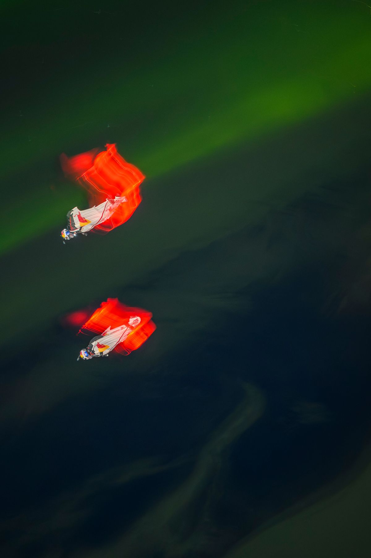 Jeff Provenzano and Jon DeVore wingsuit skydiving under the Aurora Borealis near Palmer, Alaska on March 23, 2026.