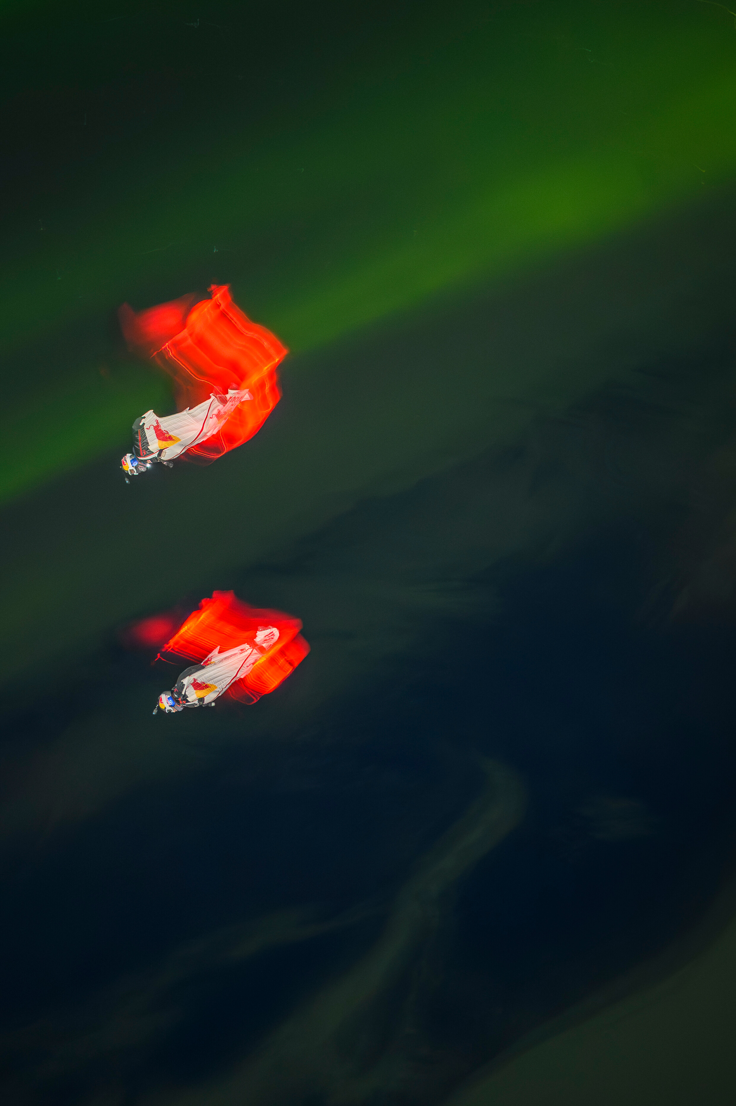 Jeff Provenzano and Jon DeVore wingsuit skydiving under the Aurora Borealis near Palmer, Alaska on March 23, 2026.