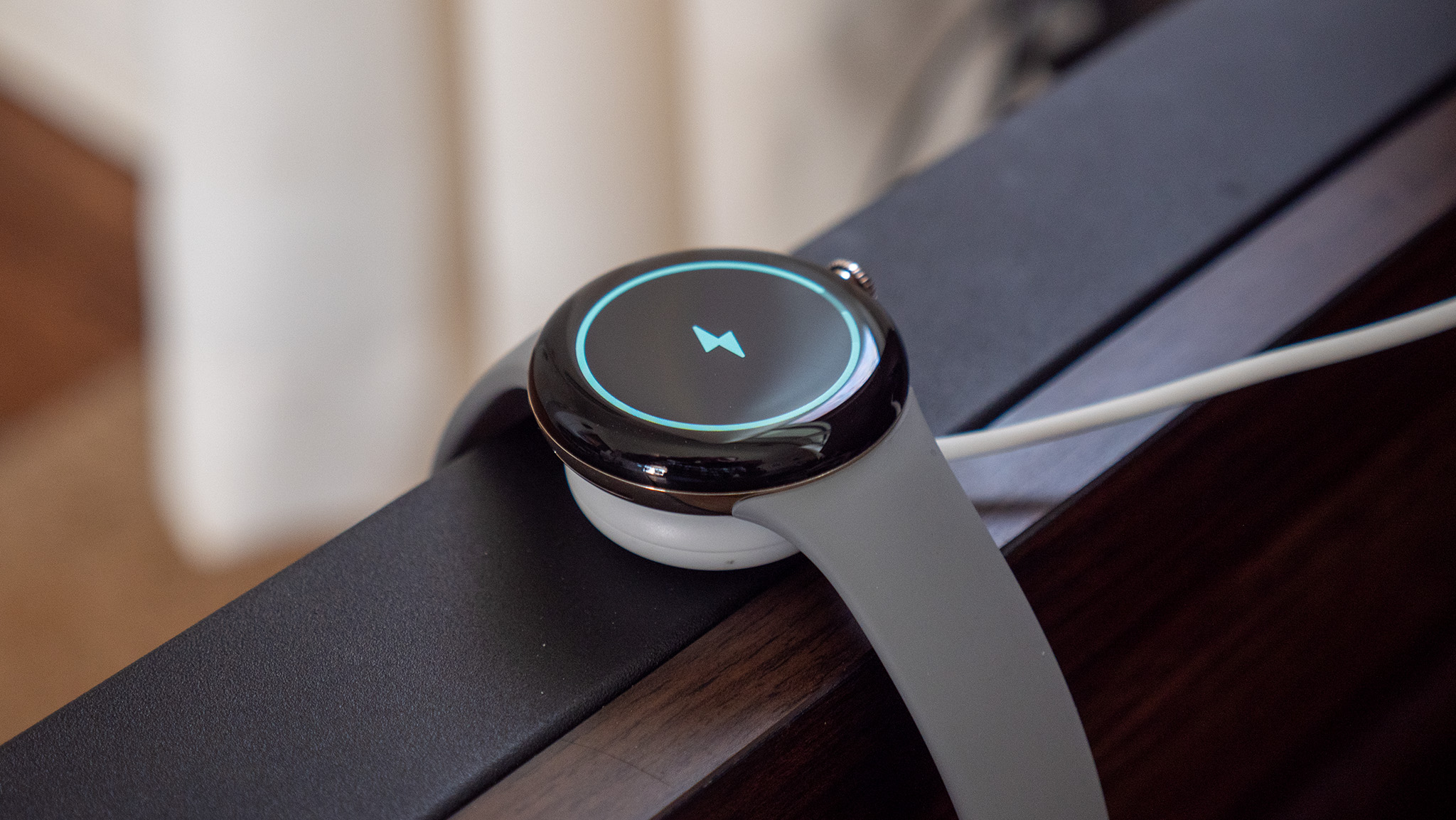 Google Pixel Watch charging on the included magnetic dock
