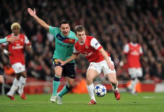 Jack Wilshere of Arsenal takes on Xavi of Barcelona during the UEFA Champions League round of 16 first leg match between Arsenal and Barcelona at the Emirates Stadium on February 16, 2011 in London, England.