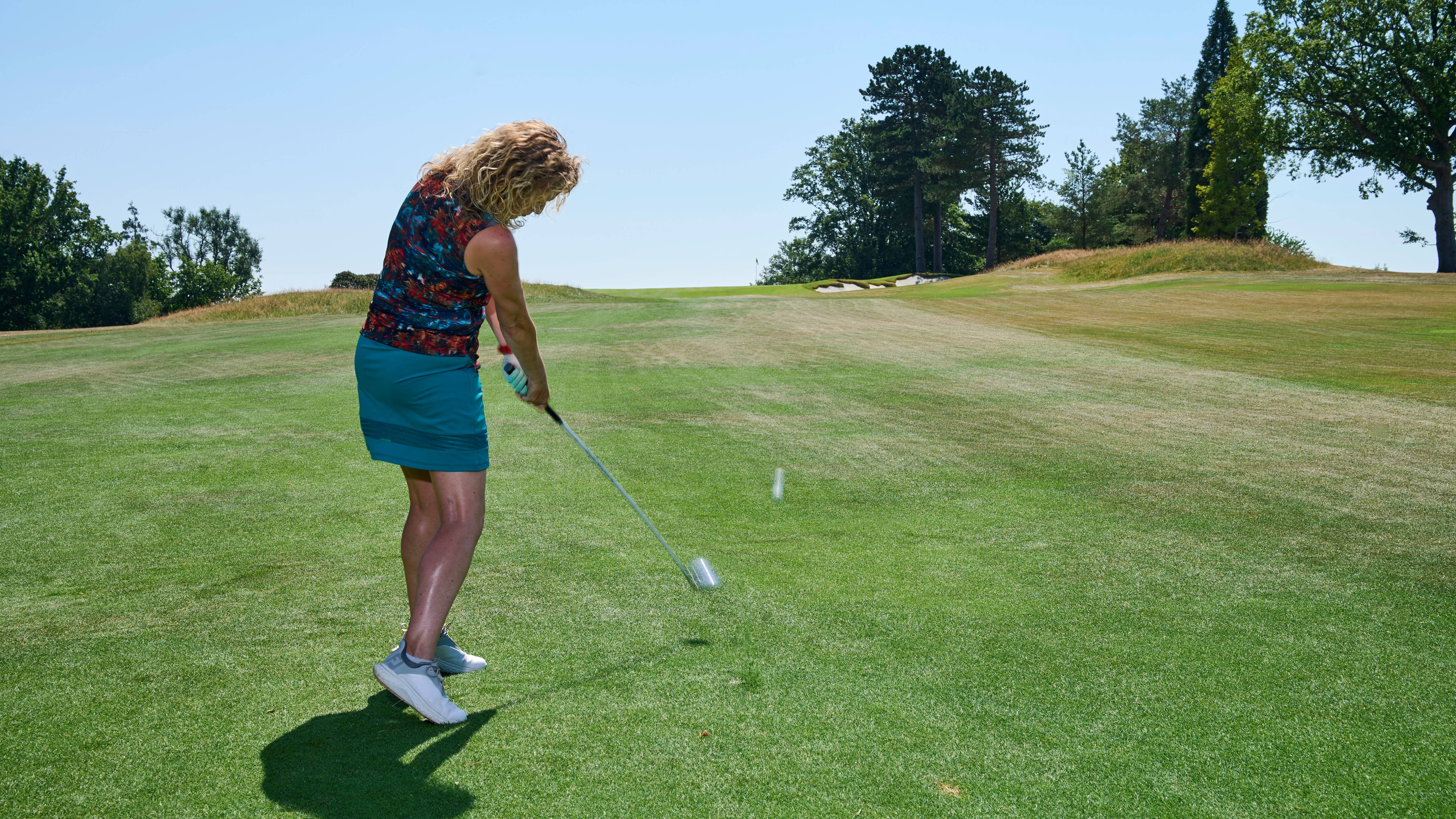 Katie Dawkins striking a 7-wood